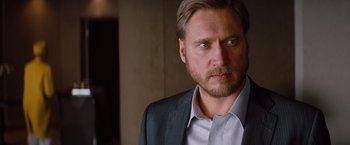 Movie still from “Mission: Impossible - Ghost Protocol” (2011), directed by Brad Bird – A person wearing a suit and tie; Close Up shot, Over the shoulder angle