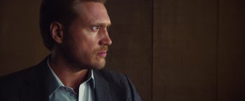 Movie still from “Mission: Impossible - Ghost Protocol” (2011), directed by Brad Bird – A person wearing a suit and tie; Close Up shot, Low angle