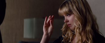Movie still from “Mission: Impossible - Ghost Protocol” (2011), directed by Brad Bird – A beautiful blonde haired woman holding her hand up to her face; Close Up shot, Over the shoulder angle