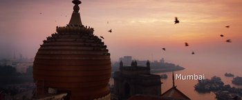 Movie still from “Mission: Impossible - Ghost Protocol” (2011), directed by Brad Bird – Birds flying over a city at sunset with a view; Extreme Wide shot, Low angle
