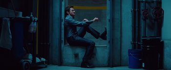 Movie still from “Mission: Impossible - Ghost Protocol” (2011), directed by Brad Bird – A man sitting on the ground in a room; Wide shot, Low angle