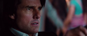 Movie still from “Mission: Impossible - Ghost Protocol” (2011), directed by Brad Bird – A person wearing a suit and tie; Close Up shot, Over the shoulder angle