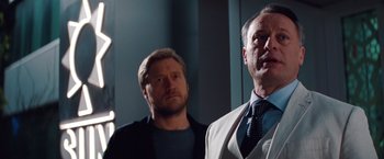 Movie still from “Mission: Impossible - Ghost Protocol” (2011), directed by Brad Bird – Two men standing next to each other in front of a wall; Close Up shot, Low angle