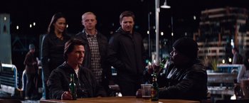 Movie still from “Mission: Impossible - Ghost Protocol” (2011), directed by Brad Bird – A group of men sitting at a table drinking beer; Medium shot, Over the shoulder angle