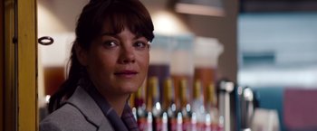 Movie still from “Mission: Impossible - Ghost Protocol” (2011), directed by Brad Bird – A woman's face in front of bottles of alcohol; Close Up shot, Over the shoulder angle