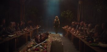 A group of people sitting around a table with food on top of it