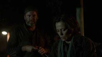 Movie still from “Oats Studios” (2017), directed by Neill Blomkamp – A man and a woman in a dark room; Medium shot, Over the shoulder angle