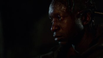 Movie still from “Oats Studios” (2017), directed by Neill Blomkamp – A man's face in the dark; Close Up shot, Low angle