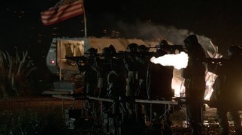 Movie still from “Oats Studios” (2017), directed by Neill Blomkamp – A group of men in military uniforms with guns; Wide shot, Low angle