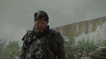 Movie still from “Oats Studios” (2017), directed by Neill Blomkamp – A man wearing a helmet and a body armor; Medium shot, Over the shoulder angle