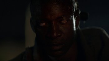Movie still from “Oats Studios” (2017), directed by Neill Blomkamp – A man's face in the dark; Extreme Close Up shot, High angle