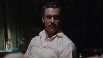 Movie still from “Oats Studios” (2017), directed by Neill Blomkamp – A person wearing a white shirt; Close Up shot, Over the shoulder angle