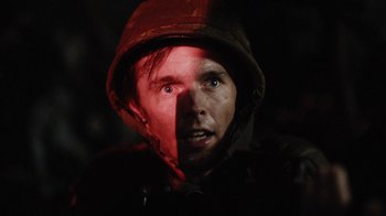 Movie still from “Oats Studios” (2017), directed by Neill Blomkamp – A man wearing a helmet with a red light shining on his face; Close Up shot, Low angle