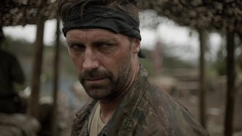 Movie still from “Oats Studios” (2017), directed by Neill Blomkamp – A person wearing a head band; Close Up shot, Over the shoulder angle