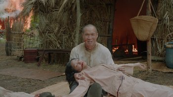 Movie still from “Oats Studios” (2017), directed by Neill Blomkamp – An older man and a younger woman are sitting on the ground; Medium shot, Over the shoulder angle