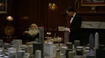 Movie still from “Oats Studios” (2017), directed by Neill Blomkamp – A man in a suit and a man in a black suit and a man in a white wig; Medium shot, Over the shoulder angle