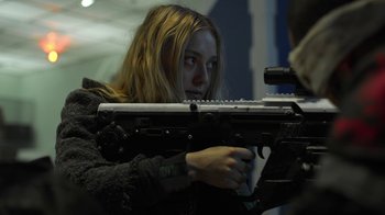 Movie still from “Oats Studios” (2017), directed by Neill Blomkamp – A woman is holding a gun in her hands; Close Up shot, Over the shoulder angle