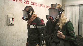 Movie still from “Oats Studios” (2017), directed by Neill Blomkamp – A man and a woman wearing gas masks; Medium shot, Low angle