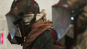 Movie still from “Oats Studios” (2017), directed by Neill Blomkamp – A man wearing a leather jacket and a mask; Close Up shot, Low angle