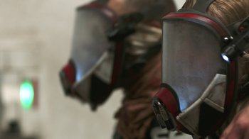 Movie still from “Oats Studios” (2017), directed by Neill Blomkamp – View of a person wearing a metal helmet; Extreme Close Up shot, Low angle