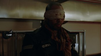Movie still from “Oats Studios” (2017), directed by Neill Blomkamp – A blindfolded man wearing a black jacket; Close Up shot, Over the shoulder angle