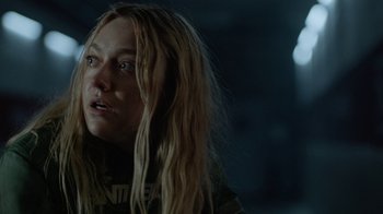 Movie still from “Oats Studios” (2017), directed by Neill Blomkamp – A person with long blonde hair; Close Up shot, Over the shoulder angle
