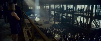 Movie still from “Okja” (2017), directed by Bong Joon Ho – A crowd of people sitting in front of a stage; Extreme Wide shot, High angle