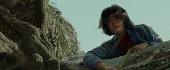 Movie still from “Okja” (2017), directed by Bong Joon Ho – A young child is climbing a rock wall; Close Up shot, Low angle