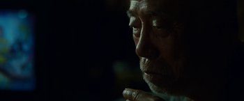 Movie still from “Okja” (2017), directed by Bong Joon Ho – An older man is looking down at his face; Close Up shot, Over the shoulder angle