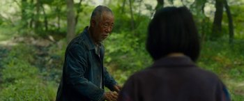 Movie still from “Okja” (2017), directed by Bong Joon Ho – An older man in a denim jacket talking to a woman; Medium shot, Over the shoulder angle