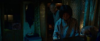 Movie still from “Okja” (2017), directed by Bong Joon Ho – A man and a woman are standing in front of a building; Medium shot, Over the shoulder angle