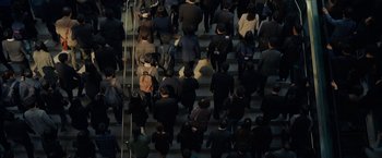 Movie still from “Okja” (2017), directed by Bong Joon Ho – A group of people walking up some stairs; Extreme Wide shot, High angle