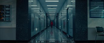 Movie still from “Okja” (2017), directed by Bong Joon Ho – A person is walking down a hallway in a building; Extreme Wide shot, High angle