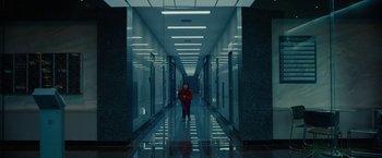 Movie still from “Okja” (2017), directed by Bong Joon Ho – A person standing in a hallway of an office building; Extreme Wide shot, High angle