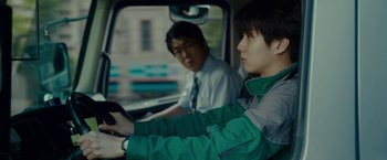 Movie still from “Okja” (2017), directed by Bong Joon Ho – A man and a woman in the back seat of a car; Close Up shot, Over the shoulder angle