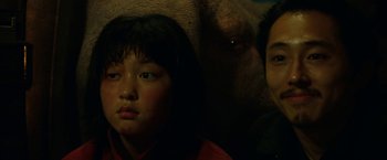 Movie still from “Okja” (2017), directed by Bong Joon Ho – Two children are standing next to an elephant; Close Up shot, Low angle