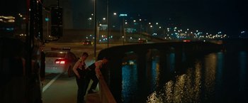 Movie still from “Okja” (2017), directed by Bong Joon Ho – A couple of men standing on a bridge over a river at night; Wide shot, Low angle