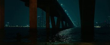 Movie still from “Okja” (2017), directed by Bong Joon Ho – A view of a bridge that is lit up at night; Extreme Wide shot, High angle