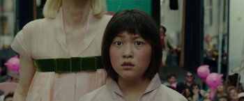 Movie still from “Okja” (2017), directed by Bong Joon Ho – A young girl is looking into the camera; Close Up shot, Low angle