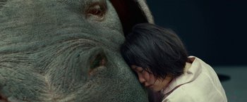 Movie still from “Okja” (2017), directed by Bong Joon Ho – A woman is hugging an elephant's head; Close Up shot, Low angle