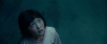 Movie still from “Okja” (2017), directed by Bong Joon Ho – A woman with blue eyes looking up at the sky; Close Up shot, High angle