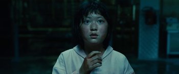 Movie still from “Okja” (2017), directed by Bong Joon Ho – A young girl is looking into the camera; Close Up shot, High angle