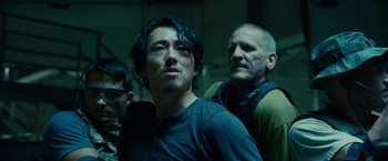 Movie still from “Okja” (2017), directed by Bong Joon Ho – A group of men standing next to each other in a room; Close Up shot, Low angle