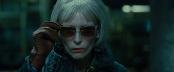 Movie still from “Okja” (2017), directed by Bong Joon Ho – A woman with white hair wearing sunglasses and a jacket; Close Up shot, Low angle