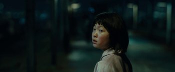 Movie still from “Okja” (2017), directed by Bong Joon Ho – A young girl is looking into the distance; Close Up shot, High angle