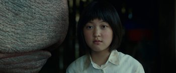 Movie still from “Okja” (2017), directed by Bong Joon Ho – A young asian girl with short black hair; Close Up shot, Low angle