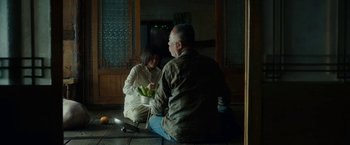 Movie still from “Okja” (2017), directed by Bong Joon Ho – A man and a woman sitting on the ground; Medium shot, Over the shoulder angle