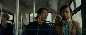 Movie still from “Okja” (2017), directed by Bong Joon Ho – A man sitting on a bus looking out the window; Close Up shot, Over the shoulder angle