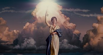 A statue of a woman holding up a light in the sky