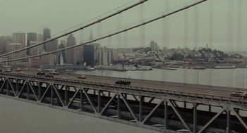Movie still from “Moneyball” (2011), directed by Bennett Miller – A view of a bridge with a view of a city; Extreme Wide shot, High angle